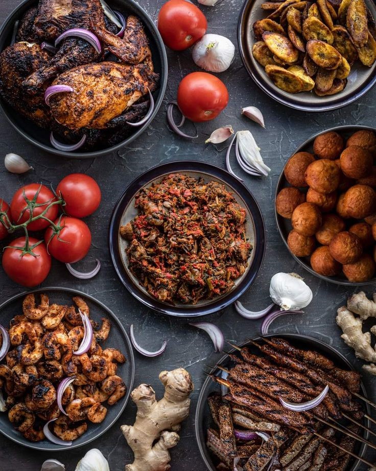 Nigerian outdoor catering spread with grilled chicken, suya, shrimp and plantain